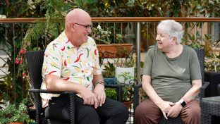 Resident and chaplain chat in the garden.