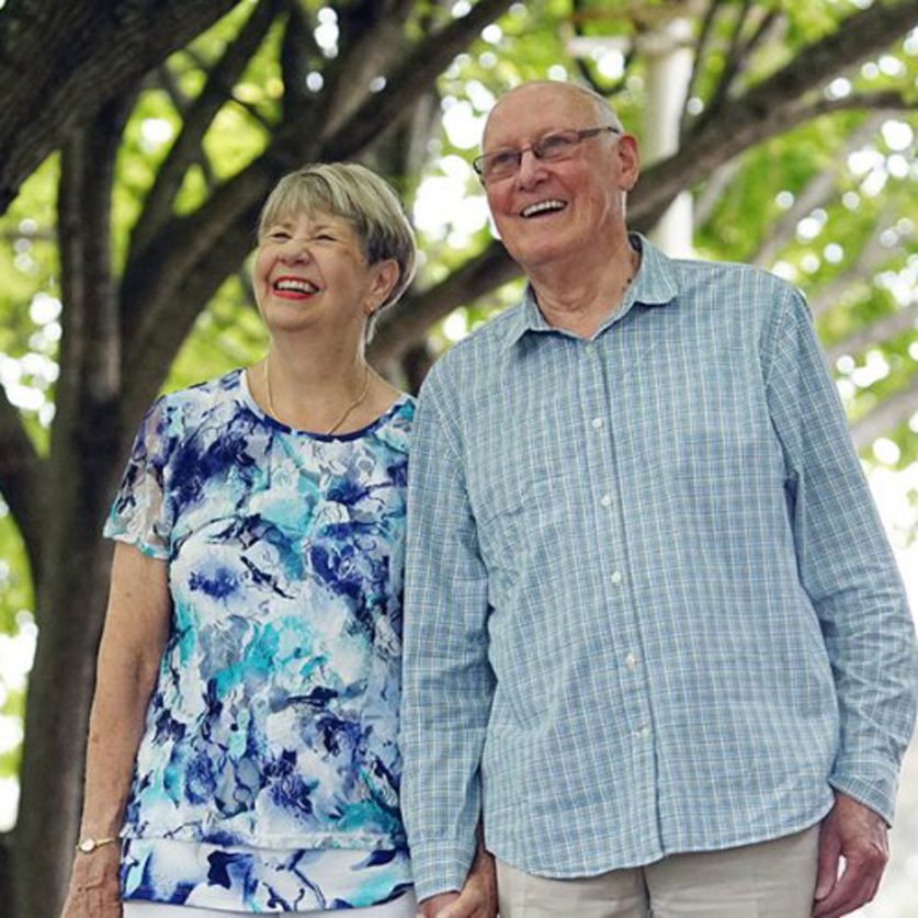 Couple pictured holding hands on a walk.