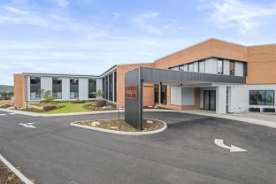 The front entrance of the residential site is photographed.