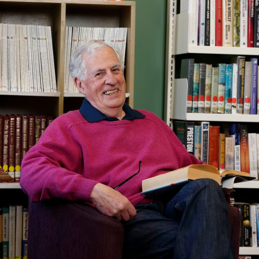 Resident reading in library.