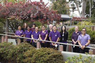 Team members of Camberwell Community, Condare Court standing in the garden