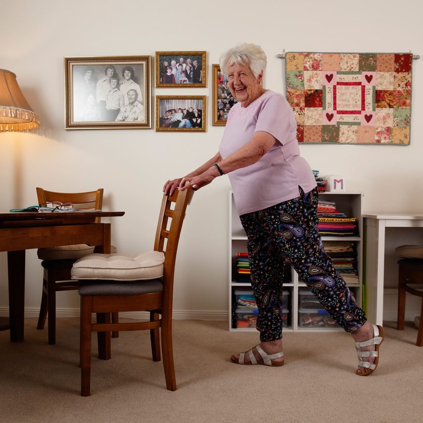 A customer is pictured completing online exercise at home with furnitures.