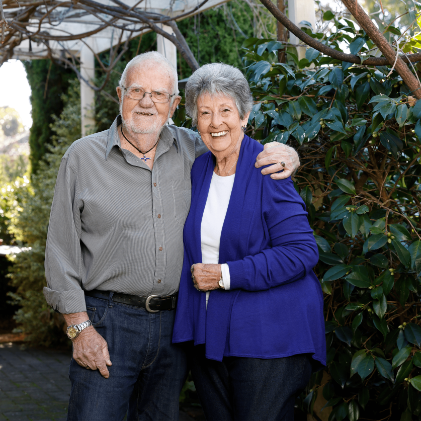 Portrait of two people in front garden.